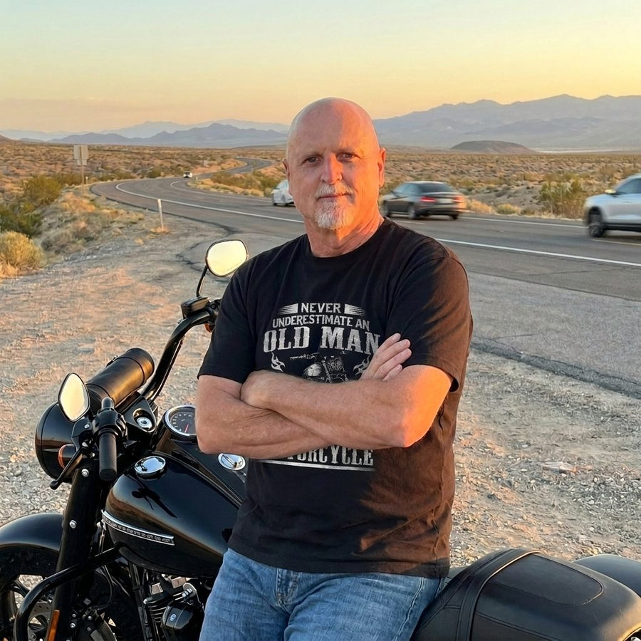 RIP MOTO crew rider in the Never Old Man tee at a desert overlook