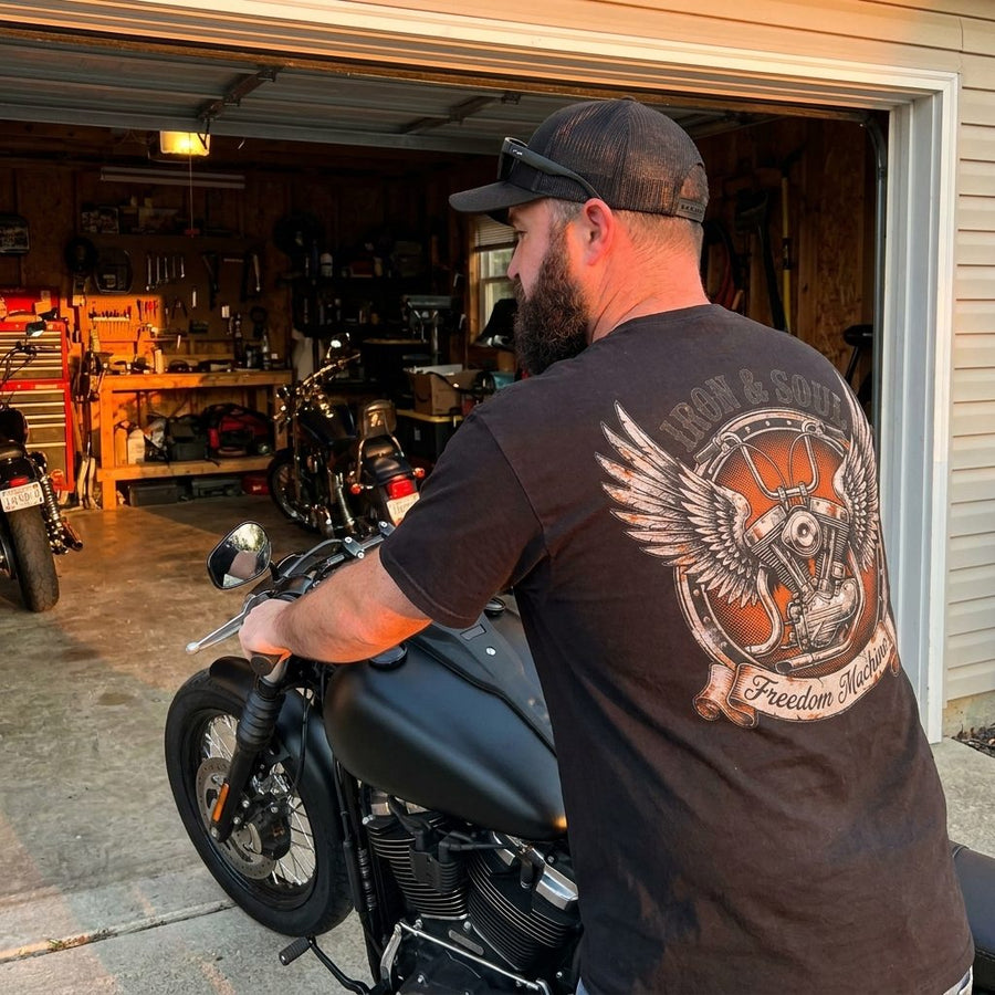 RIP MOTO crew rider showing the Iron and Soul back print in the garage