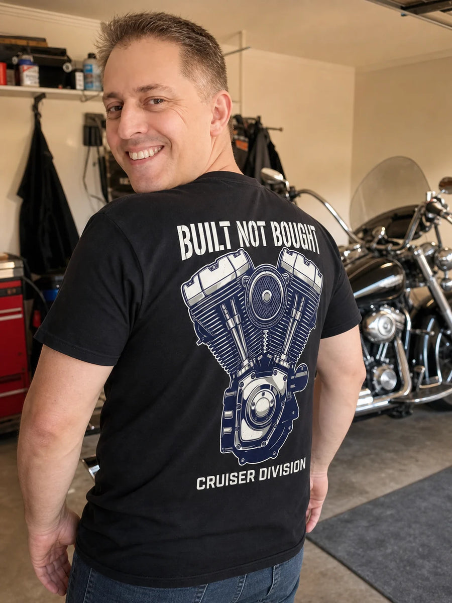 Rider wearing the RIP MOTO Built Not Bought T-Shirt beside a motorcycle