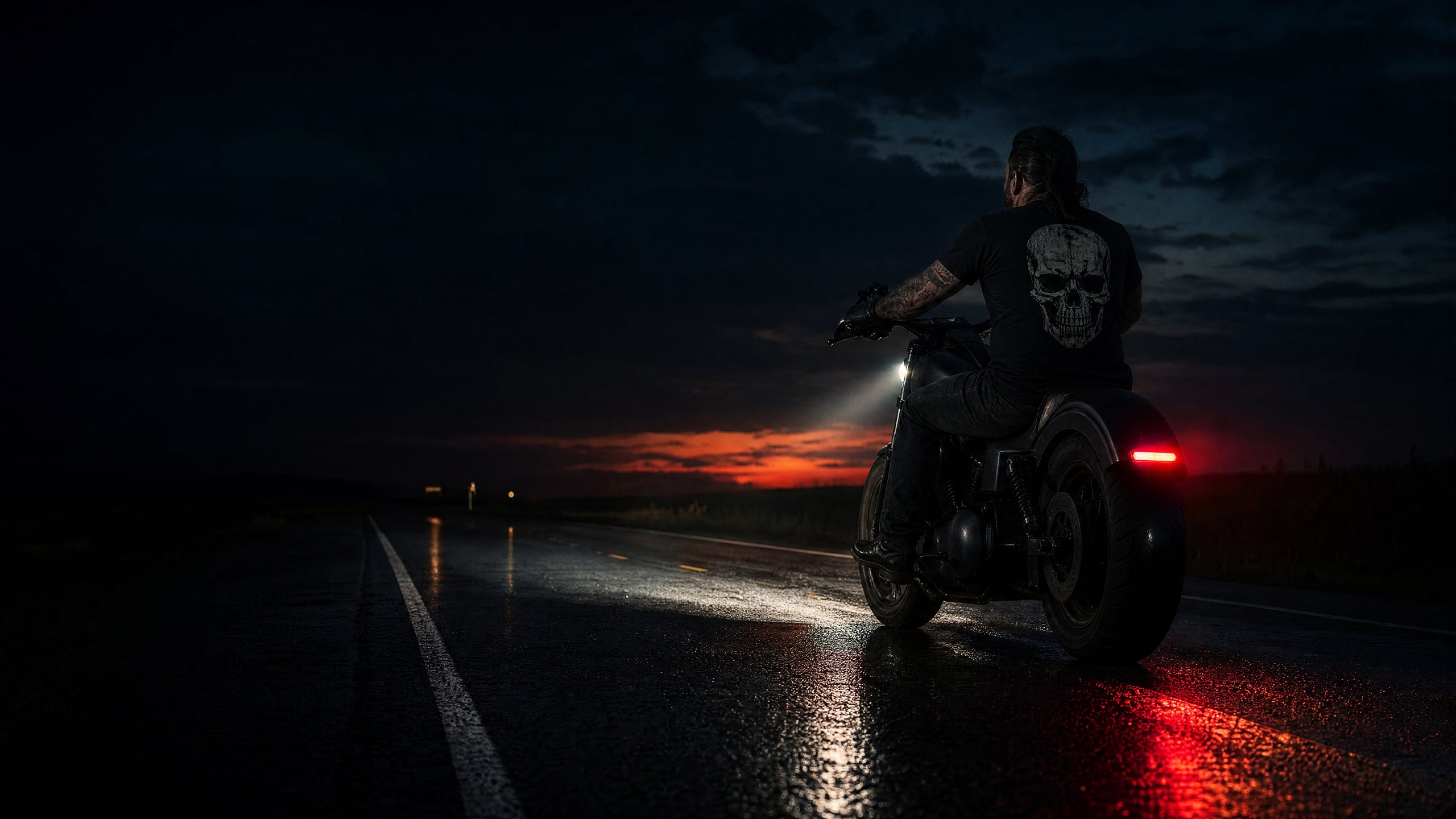 Night rider on wet highway at dusk, skull back print, red taillight glow
