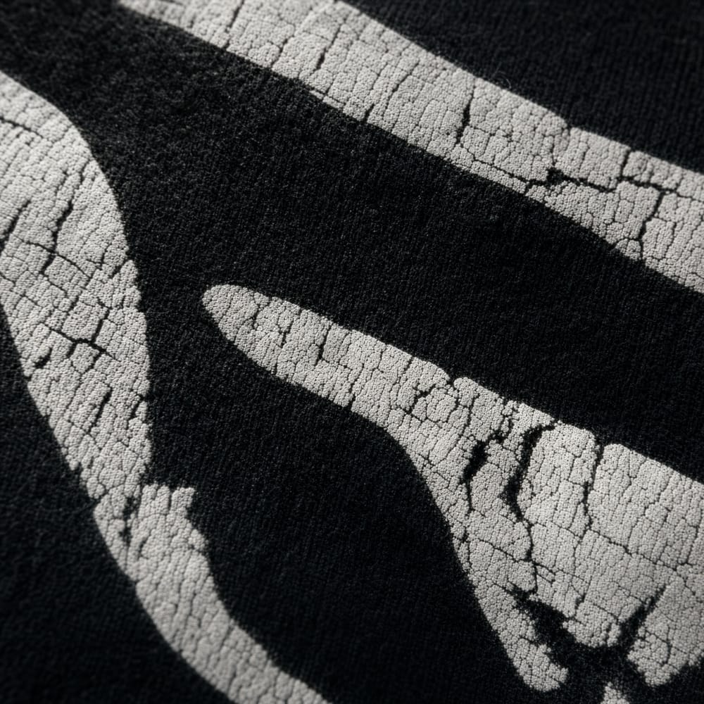 Macro of cracked distressed print on black cotton