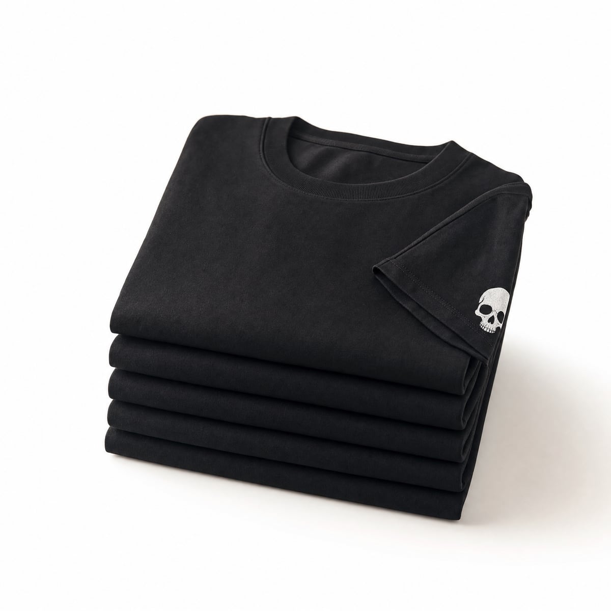 Folded stack of black RIP MOTO tees on white background
